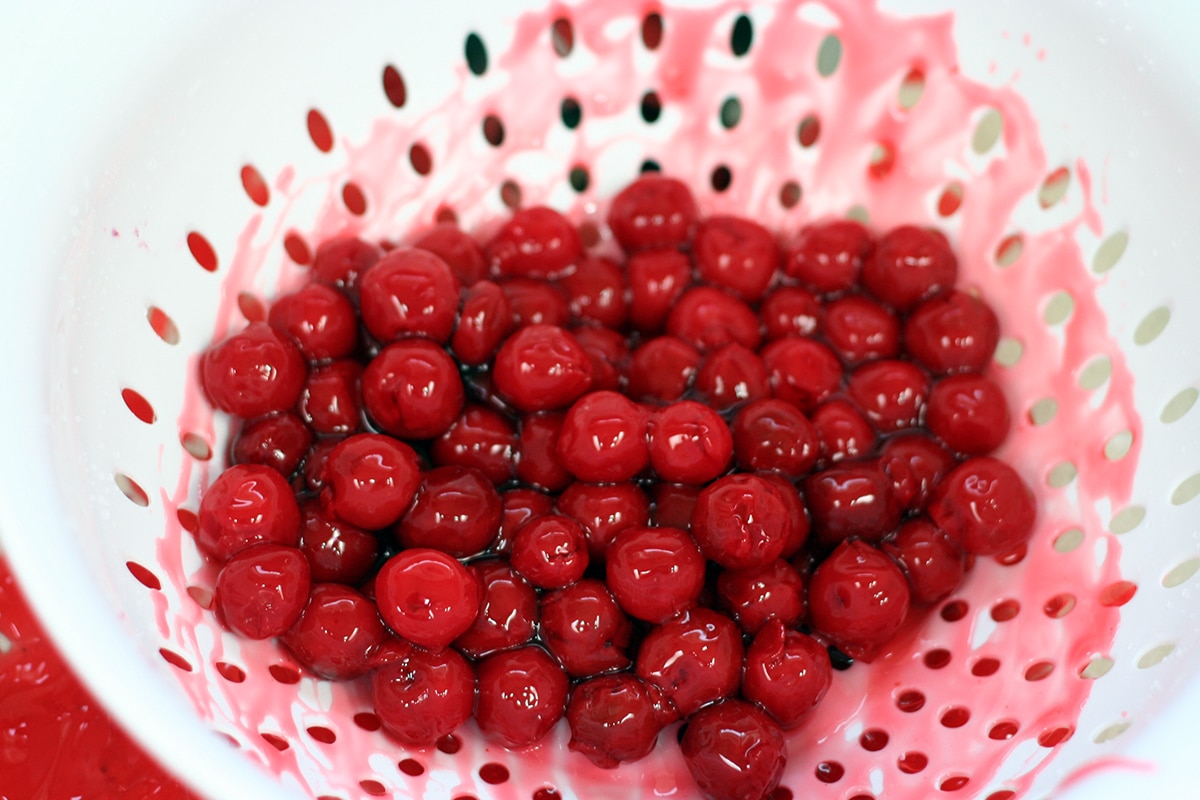 canned cherry filling in a colander