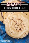 corn tortillas on a blue towel with a pinterest title banner over the top