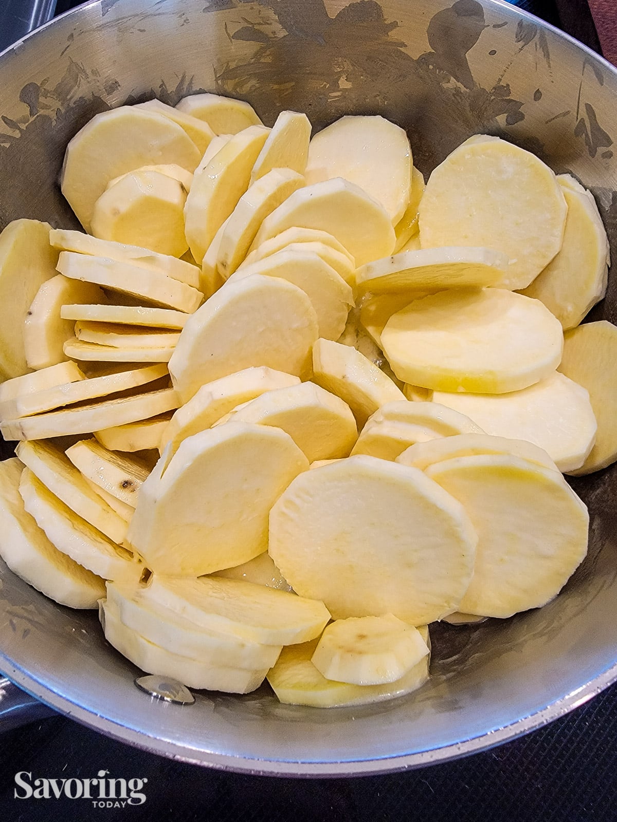 sliced sweet poatoes in a saucepan