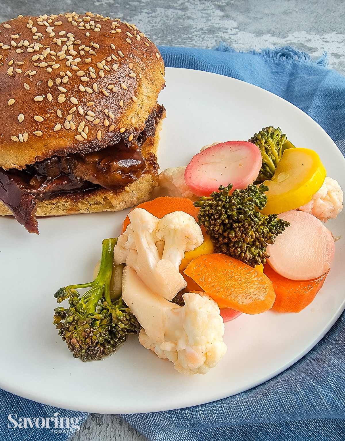 pickled vegetables served as a side dish for brisket sandwich on a white plate