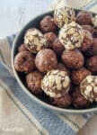 almond vanilla protein energy bites (balls) in a blue bowl on a towel