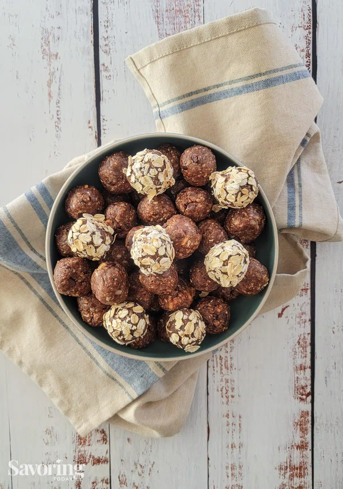 protein energy ball snacks in a blue bowl on a wood table