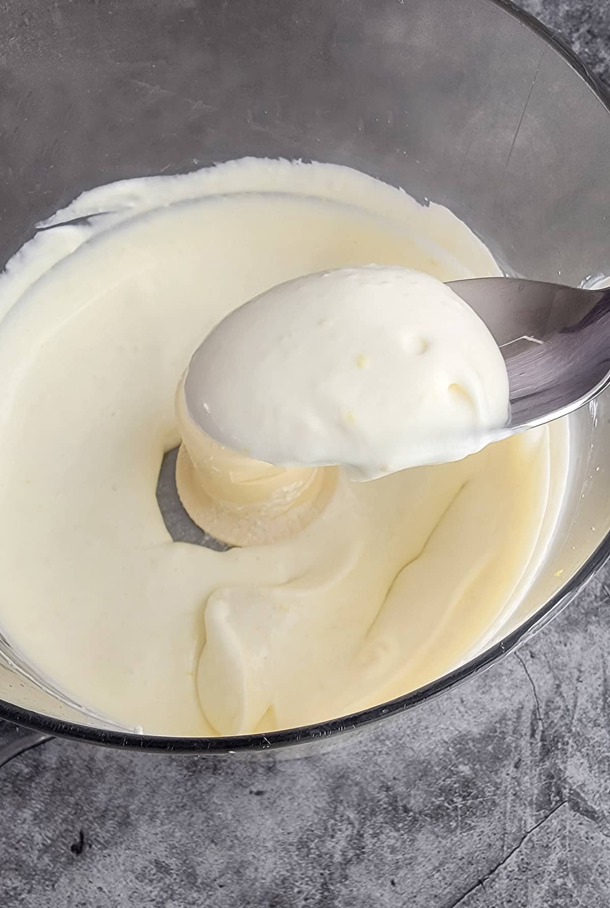 whipped ricotta and feta in a food processor with a dollop on a spoon