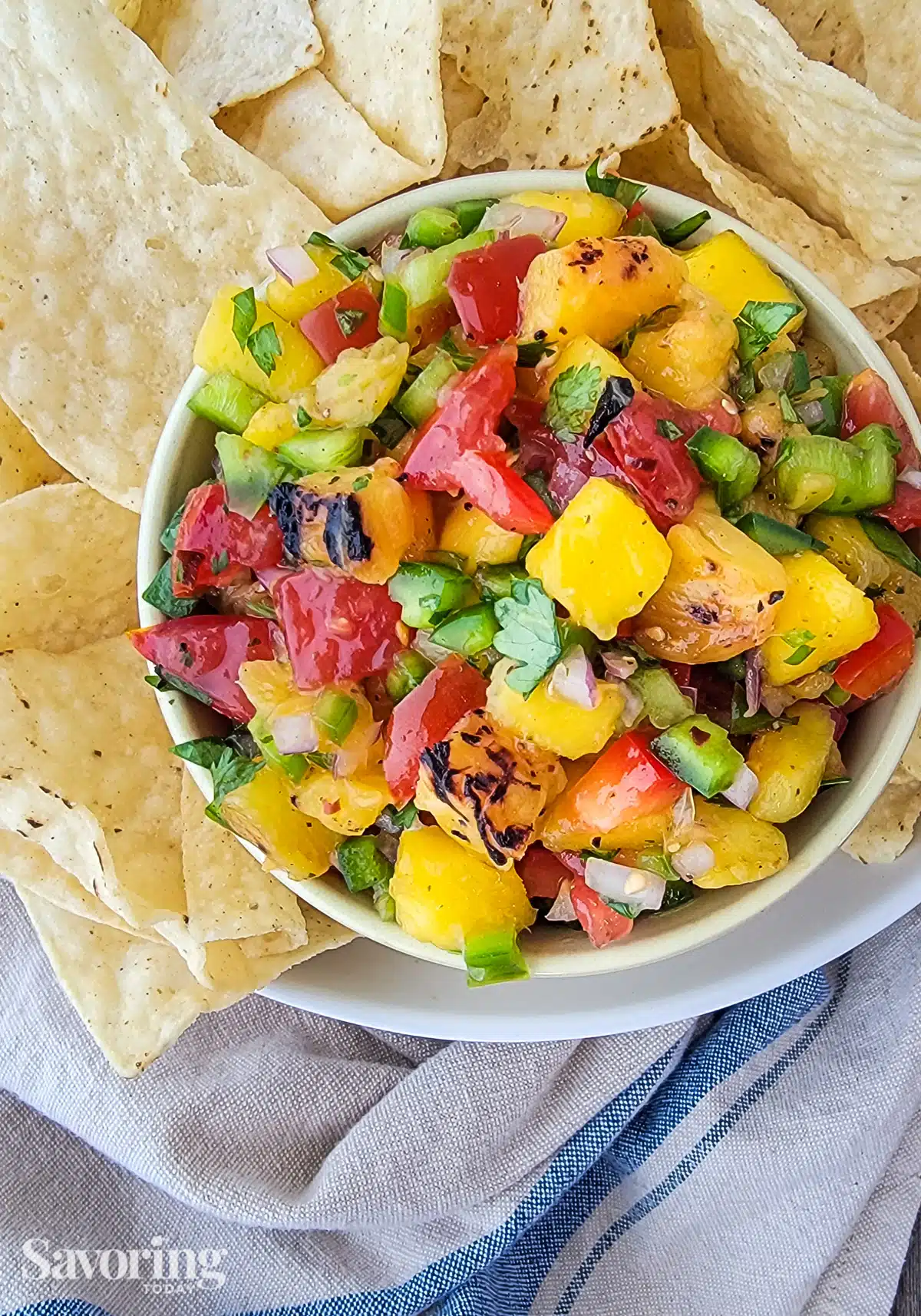 salsa with mango and pineapple in a bowl by chips