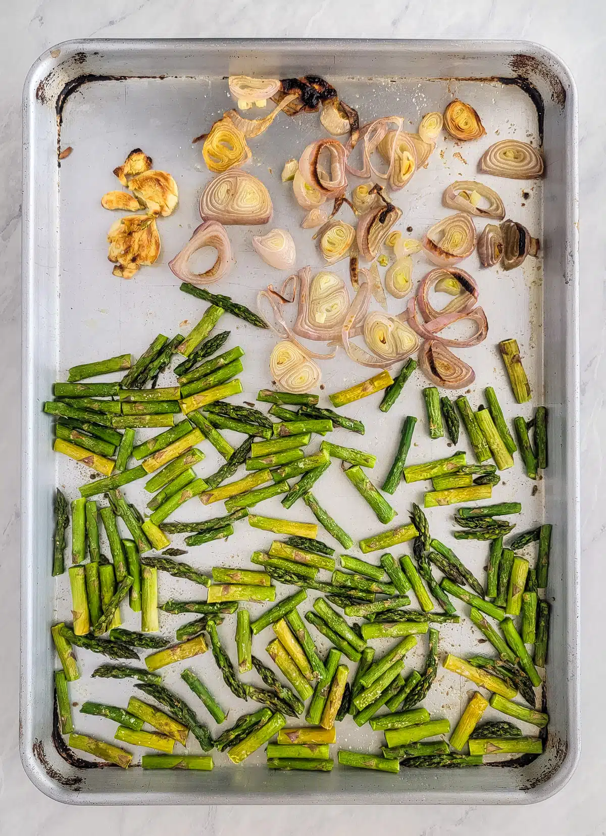 roasted asparagus and shallots on a pan