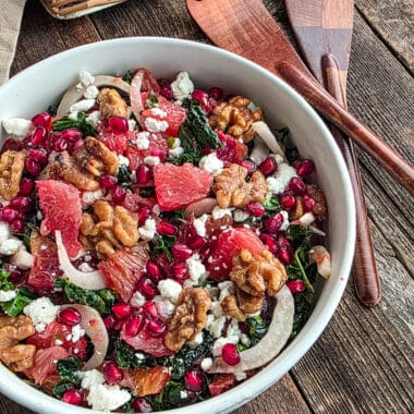 Grapefruit and blood orange salad with kale and fennel on a wood table