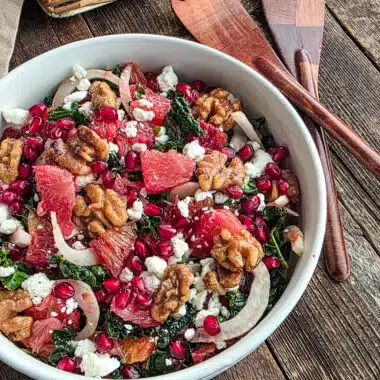 Grapefruit and blood orange salad with kale and fennel on a wood table