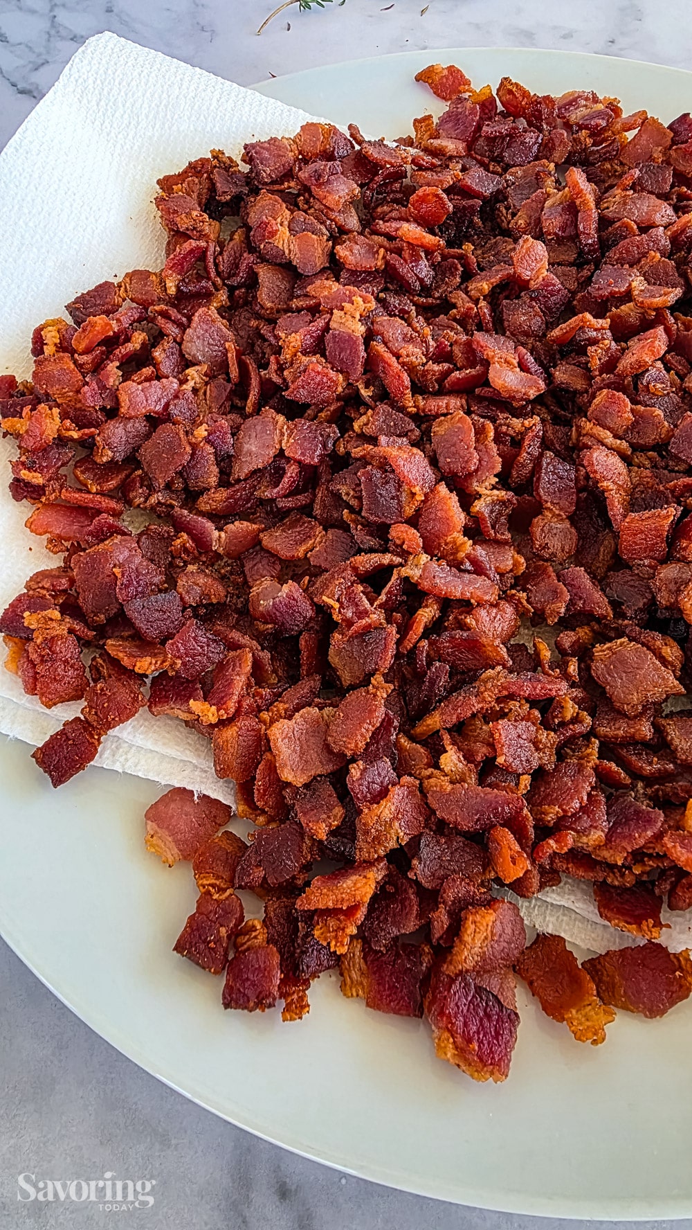 crispy bacon on a paper-towel-lined plate