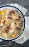 creamy seafood chowder in a white bowl on a white napkin