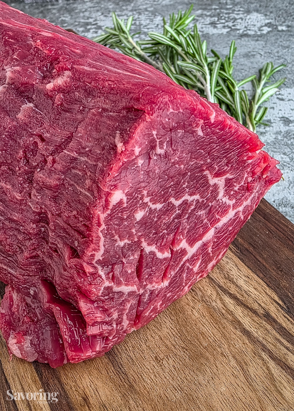 center-cut Beef tenderloin on a cutting board cut to show marbling in the meat
