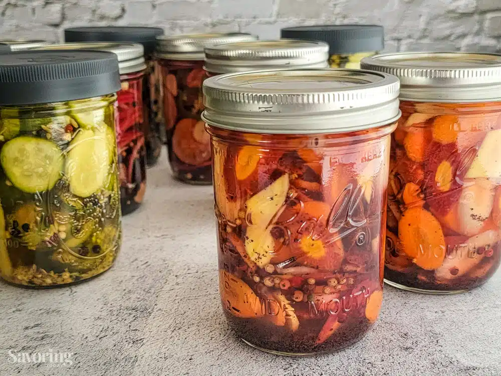 multiple jars of quick pickles on a counter