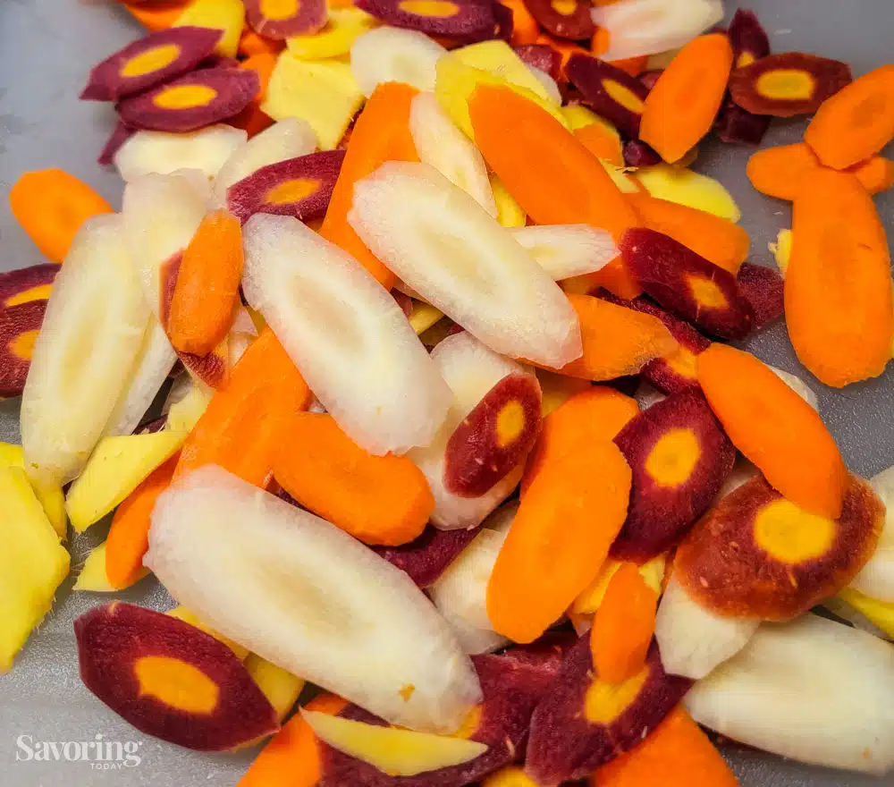sliced rainbow carrots on a cutting board
